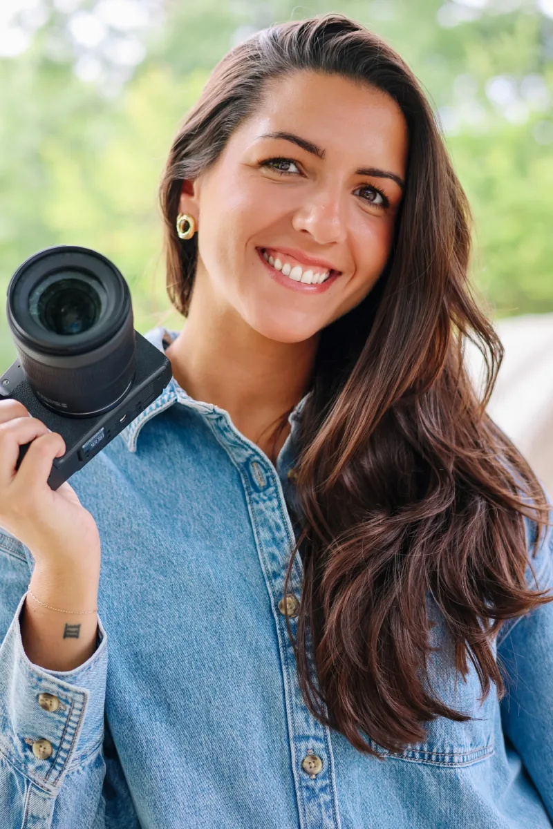 Daniela, co-founder of D&A Creative Co., holding a camera